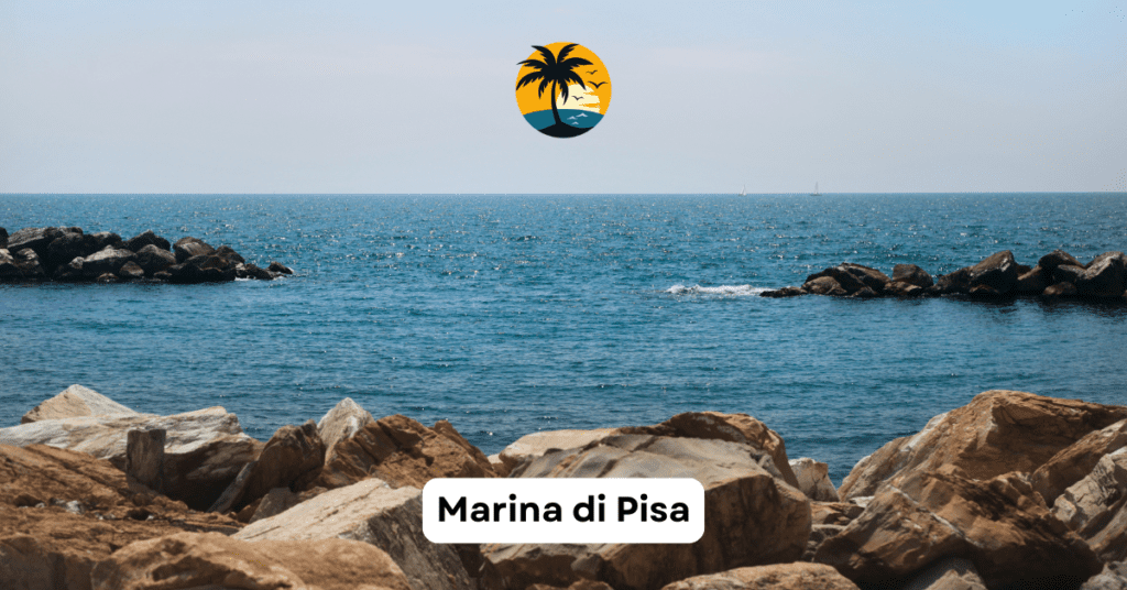 Tranquil Marina di Pisa with pebbled shoreline and clear blue waters near Florence, Italy