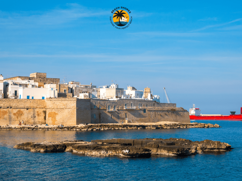 Cala Porta Vecchia, a stunning Monopoli Italy Beach with sandy shores and historic city walls.