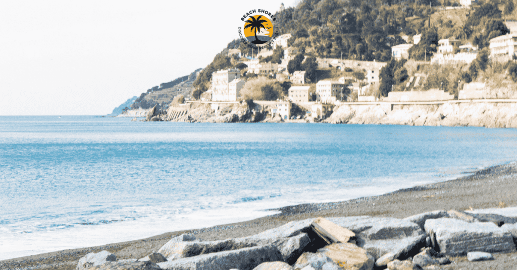 a beach with buildings and a body of water