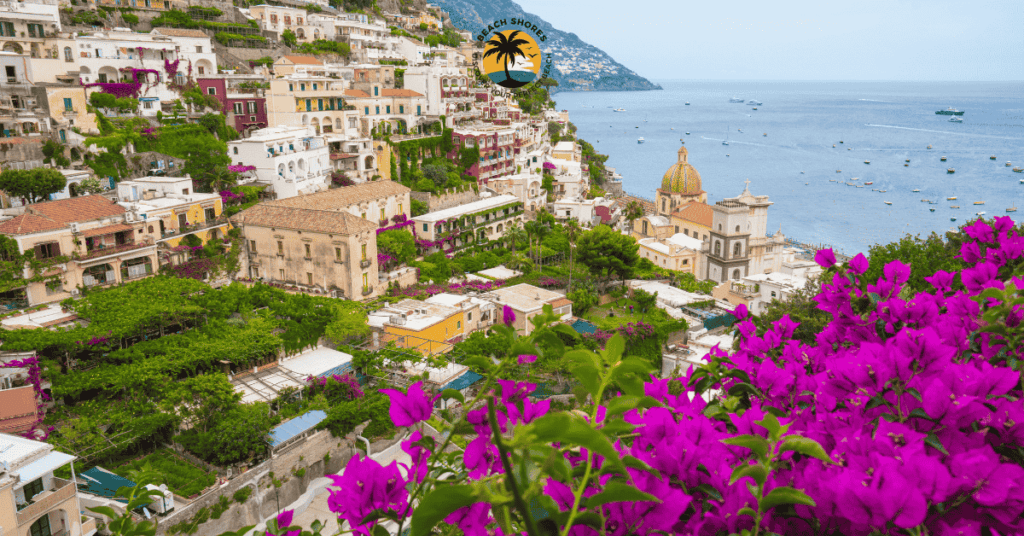 Stunning view of Amalfi Coast Italy beaches with crystal-clear waters and sunbeds along the shoreline.
