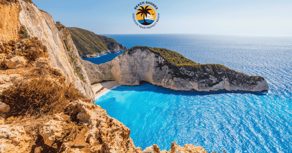 a beach with blue water and cliffs