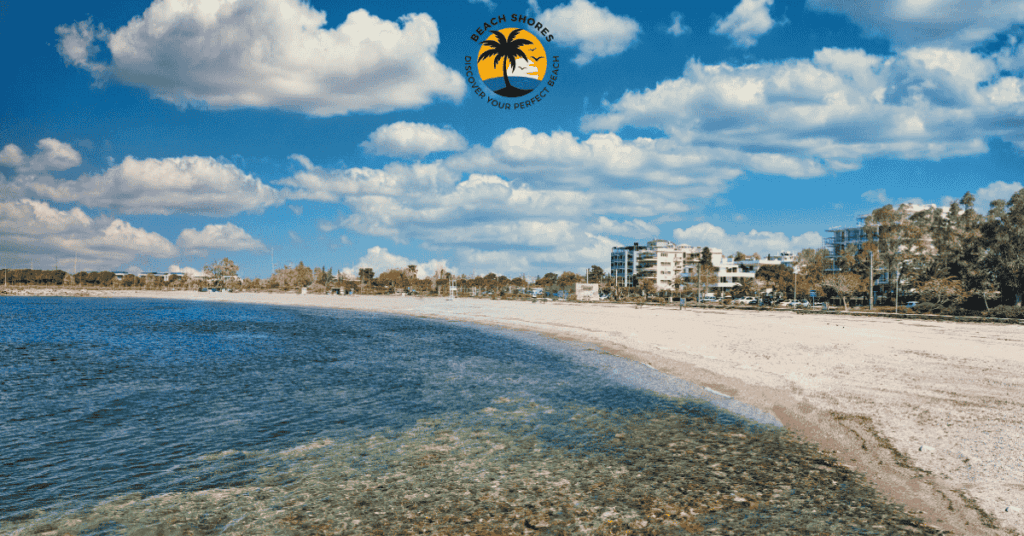 Beautiful view of Glyfada Beach in Athens, Greece, featuring clear waters, golden sand, and vibrant beach umbrellas.