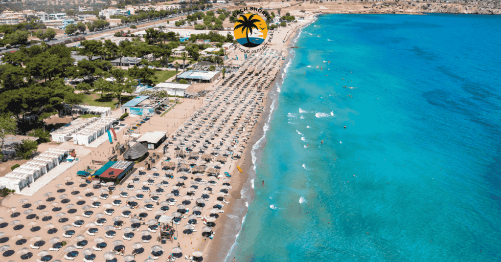 a beach with umbrellas and people swimming in the water