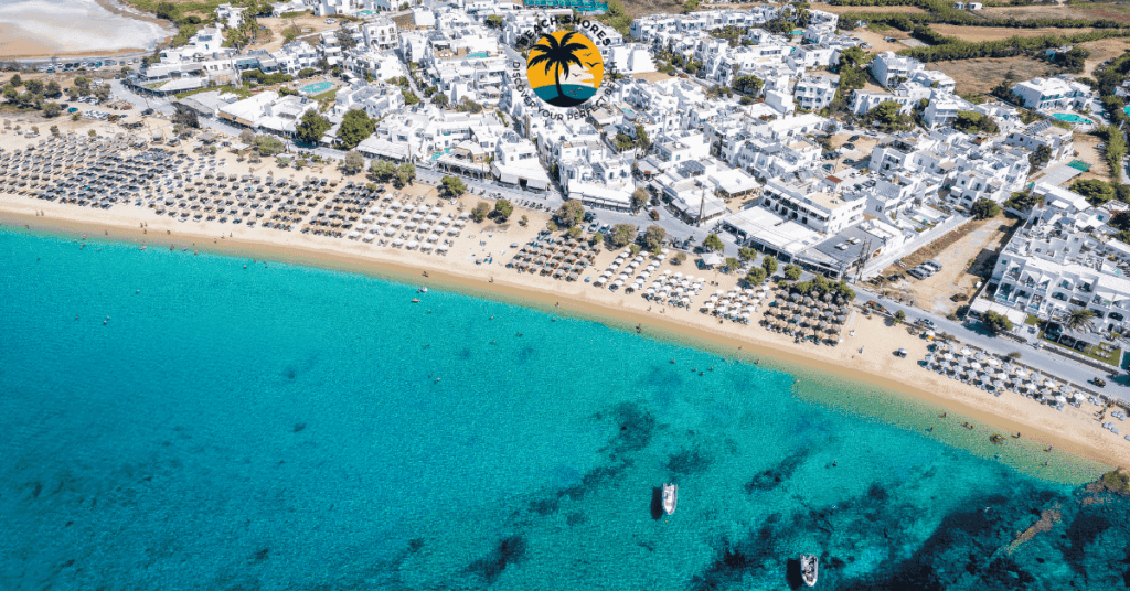 a beach with a city and boats